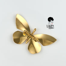 Load image into Gallery viewer, Gold butterfly-shaped Ascend Brooch with high-shine PVD plating, captured in a flat lay on its back side on a neutral background. Statement accessory symbolizing transformation and elegance.