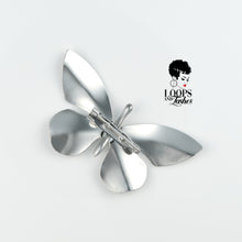 Load image into Gallery viewer, Silver butterfly-shaped Ascend Brooch made of stainless steel showing rear view, captured in a flat lay on a neutral background. Statement accessory symbolizing transformation and elegance.
