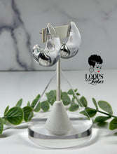 Load image into Gallery viewer, Clear Cascades are elegant earrings resembling cascading water droplets, crafted with transparent resin. Their sleek design adds a touch of sophistication to any outfit, providing a subtle yet striking accessory for all occasions.