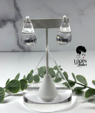Load image into Gallery viewer, Clear Cascades are elegant earrings resembling cascading water droplets, crafted with transparent resin. Their sleek design adds a touch of sophistication to any outfit, providing a subtle yet striking accessory for all occasions.