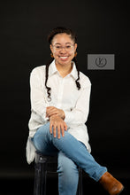 Load image into Gallery viewer, A woman elegantly wearing the Dynasty Hoops, gold-plated stainless steel earrings with a sleek, minimalist hollow design. These timeless hoops shine with a luxurious finish, symbolizing strength, sophistication, and legacy. Light yet bold, they add effortless elegance to her look, making every detail count.