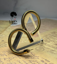 Load image into Gallery viewer, Heritage Hoops displayed against a clean background, showcasing their two-inch open hoop design with a unique textured finish. Made from stainless steel with durable PVD gold plating, these waterproof, tarnish-resistant earrings feature an exclusive engraved submark logo, blending timeless elegance with modern craftsmanship.