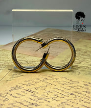 Load image into Gallery viewer, Heritage Hoops displayed against a clean background, showcasing their two-inch open hoop design with a unique textured finish. Made from stainless steel with durable PVD gold plating, these waterproof, tarnish-resistant earrings feature an exclusive engraved submark logo, blending timeless elegance with modern craftsmanship.