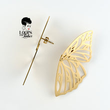Load image into Gallery viewer, Gold Fearless Wings earrings with intricate wing-inspired design, symbolizing empowerment and transformation, lightweight statement jewelry for bold, confident women. One earring shows the side view.
