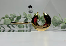 Load image into Gallery viewer, Crafted from high-quality stainless steel and meticulously PVD gold plated, the Regal Rounds are the epitome of luxury. With a bold design that effortlessly catches light, these hoops ensure you're the center of attention on any occasion. The durable stainless steel guarantees long-term use, while the PVD gold plating adds a lustrous, enduring finish. Elevate your look with the timeless allure of Regal Rounds today.