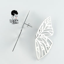 Load image into Gallery viewer, Silver Fearless Wings earrings with intricate wing-inspired design, symbolizing empowerment and transformation, lightweight statement jewelry for bold, confident women. One earring shows the side view.