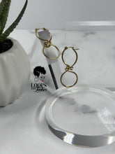 Load image into Gallery viewer, Discover the allure of these captivating infinity sign-shaped hoops featuring intricate winding at the center. Elevate your style with these unique statement pieces that embody timeless elegance. Suitable for all occasions, these earrings are a symbol of everlasting grace.