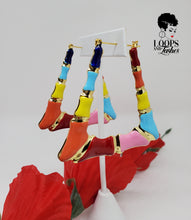 Load image into Gallery viewer, The picture is of a pair of lightweight earrings made in a classic bamboo style. The earrings are decorated with a colorful enamel finish, featuring shades of blue, orange, yellow, red and pink. The earrings have a trapezoidal shape and a gold-toned metal stem that goes through the earlobe.