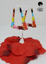 Load image into Gallery viewer, The picture is of a pair of lightweight earrings made in a classic bamboo style. The earrings are decorated with a colorful enamel finish, featuring shades of blue, orange, yellow, red and pink. The earrings have a trapezoidal shape and a gold-toned metal stem that goes through the earlobe.