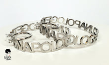 Load image into Gallery viewer, These silver custom earrings are truly for the unapologetically bold. These hoops earrings are stainless-steel and feature an openwork design with "UNAPOLOGETIC" lettering.