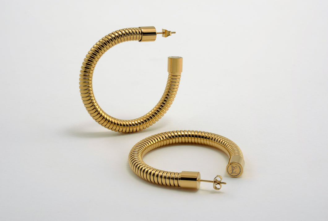 Heritage Hoops displayed against a clean background, showcasing their two-inch open hoop design with a unique textured finish. Made from stainless steel with durable PVD gold plating, these waterproof, tarnish-resistant earrings feature an exclusive engraved submark logo, blending timeless elegance with modern craftsmanship.