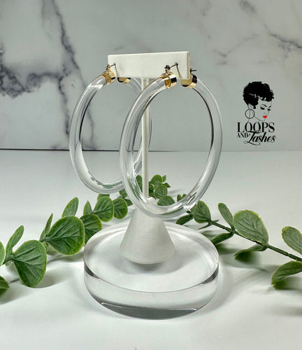 Lucid Loops are bold, lightweight clear acrylic hoop earrings, perfect for making a statement with striking clarity.