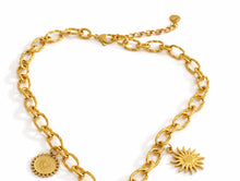 Load image into Gallery viewer, Gold chain charm necklace with sun charm on a white background showing lobster clasp
